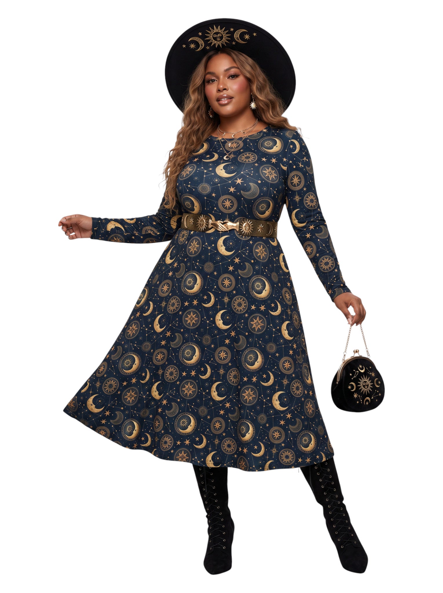 A woman modeling a long-sleeve navy blue dress with a gold celestial print of crescent moons, stars, and suns, styled with a matching gold belt, a black wide-brim hat, and black boots against a plain white background.