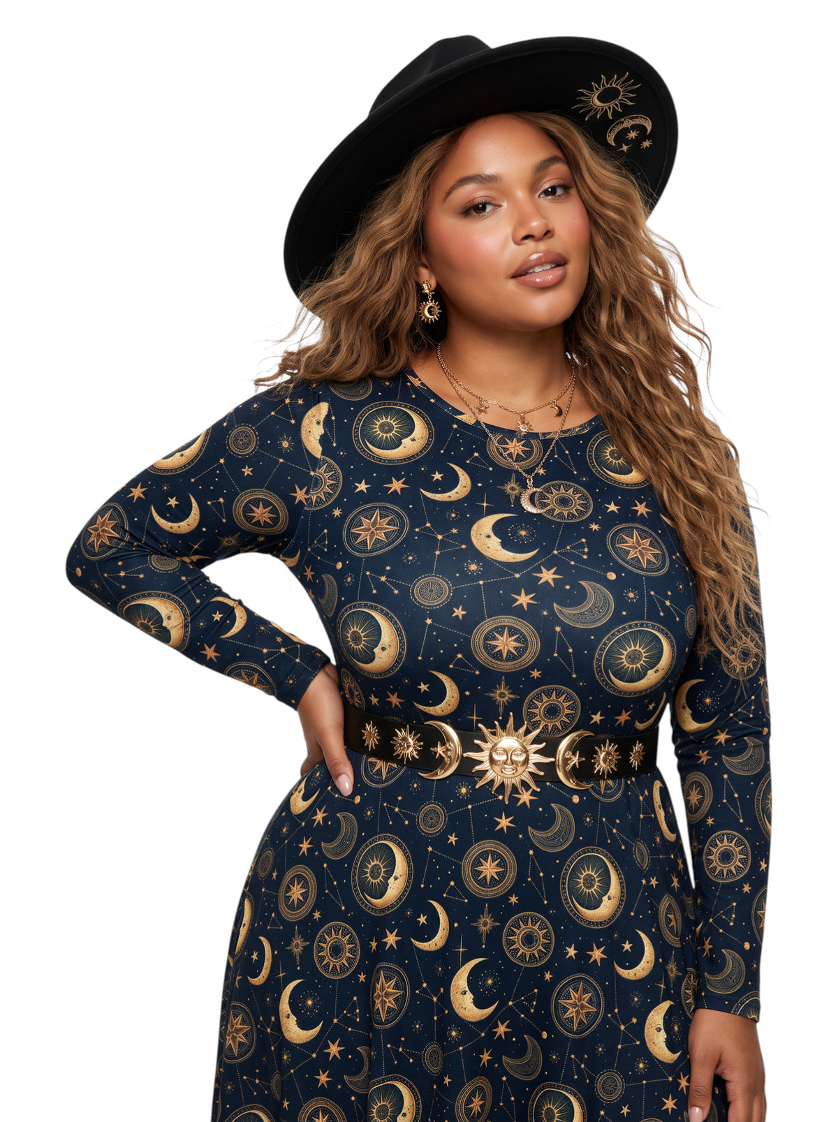 A woman modeling a long-sleeve navy dress with a gold celestial print of moons, stars, and suns, accessorized with a matching gold belt and a black wide-brim hat with a gold sun design, against a plain white background.
