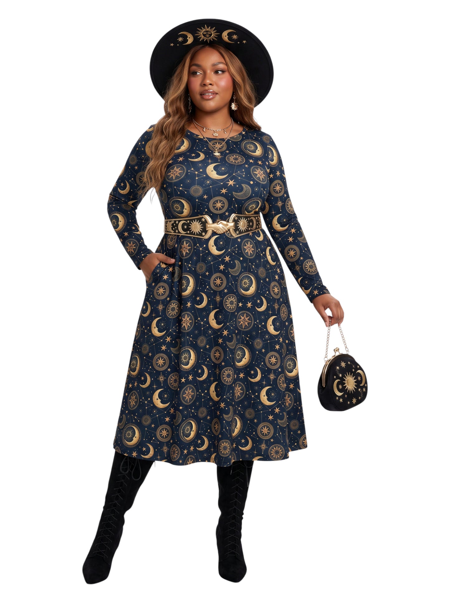 A woman modeling a long-sleeve midi dress with a celestial print of gold crescent moons and stars on a dark navy blue background. She is wearing a matching wide-brim black hat with gold celestial details, a gold belt, black boots, and holding a small matching handbag against a plain white background.