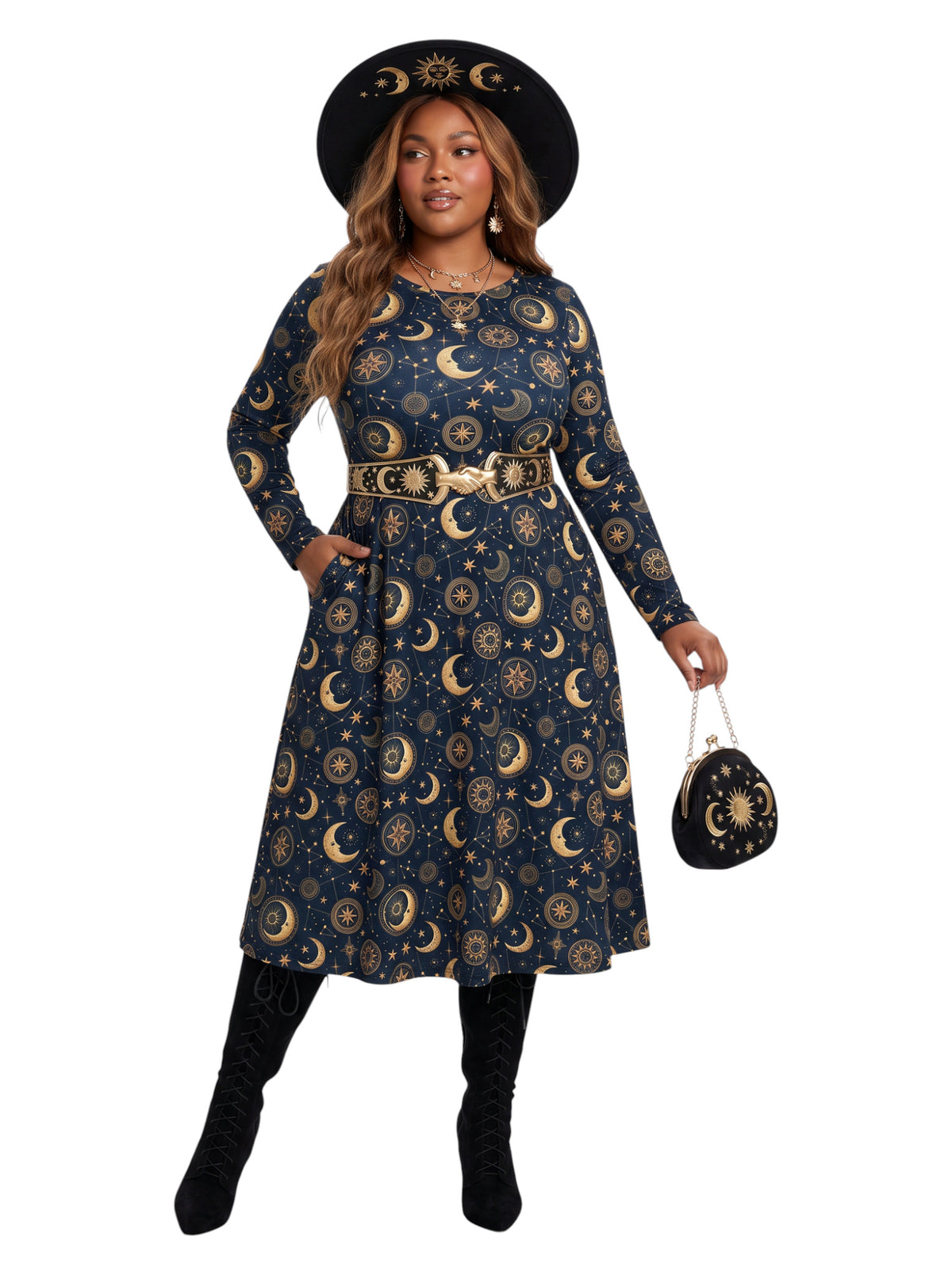A woman modeling a long-sleeve midi dress with a celestial print of gold crescent moons and stars on a dark navy blue background. She is wearing a matching wide-brim black hat with gold celestial details, a gold belt, black boots, and holding a small matching handbag against a plain white background.
