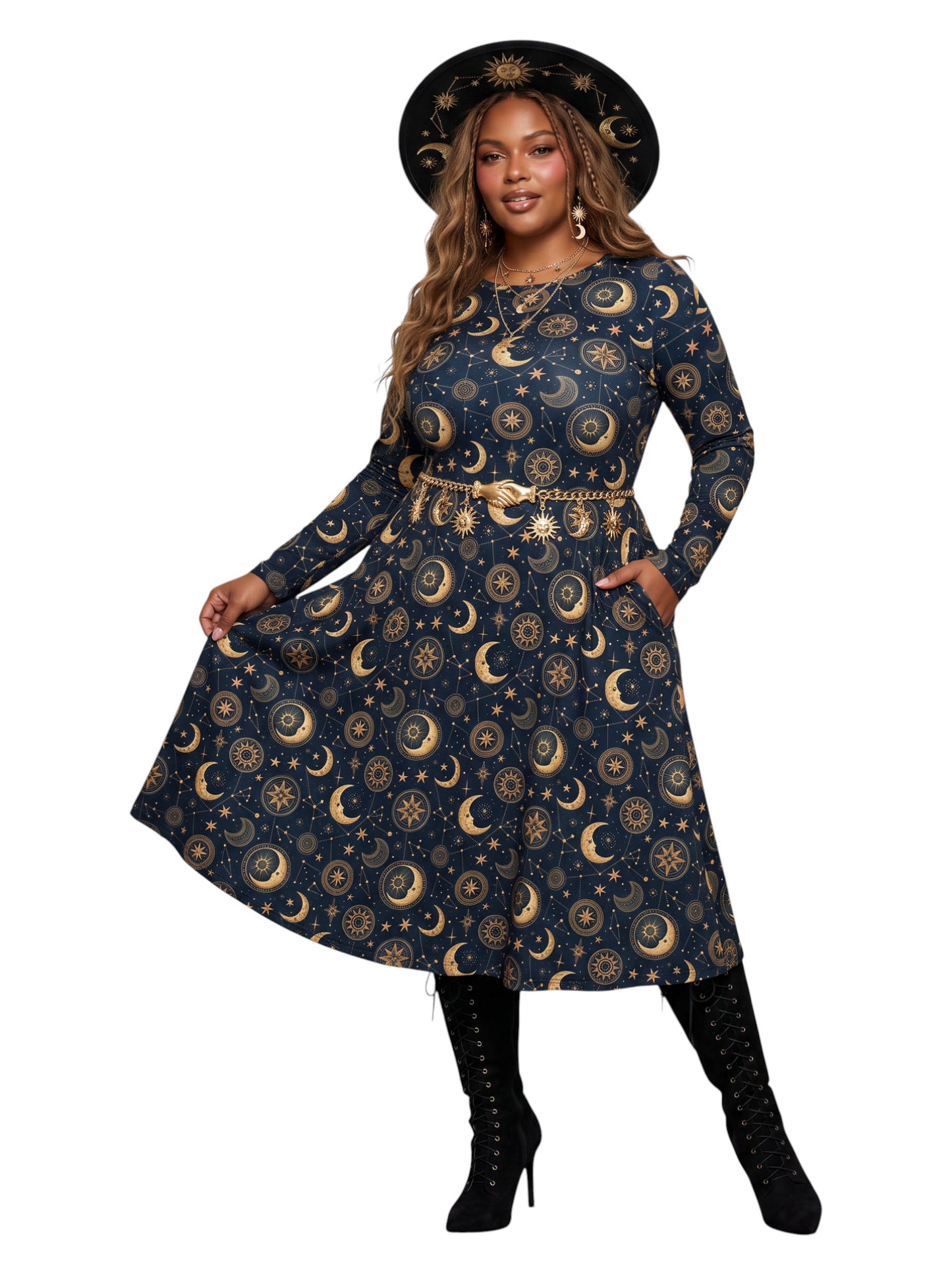 A woman modeling a long-sleeve midi dress with a celestial print of gold crescent moons and suns on a dark navy blue background. She is wearing a matching wide-brimmed black hat with gold celestial details, a gold belt, and black lace-up ankle boots, set against a plain white background.