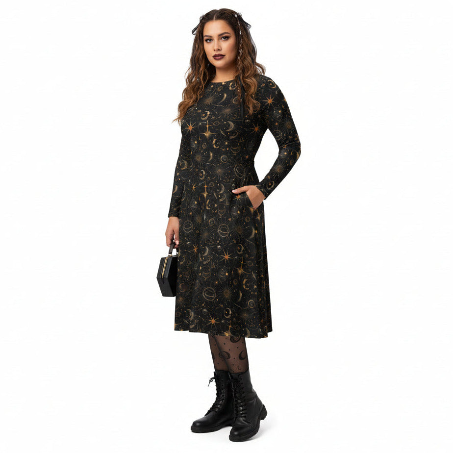 Woman wearing a black dress with celestial sun moon and stars print on a white background