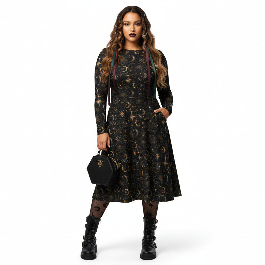 Woman wearing a black dress with celestial sun moon and stars print on a white background