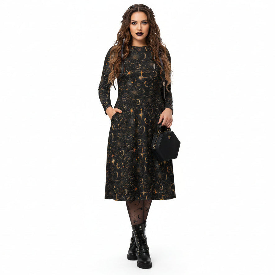 Woman wearing a black dress with celestial sun moon and stars print on a white background