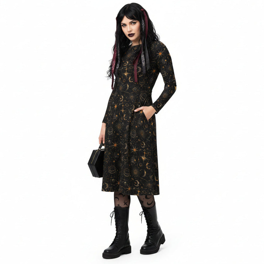 Woman wearing a black dress with star and moon pattern on a white background