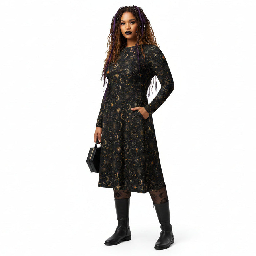 Woman wearing a black dress with celestial sun moon and stars print on a white background