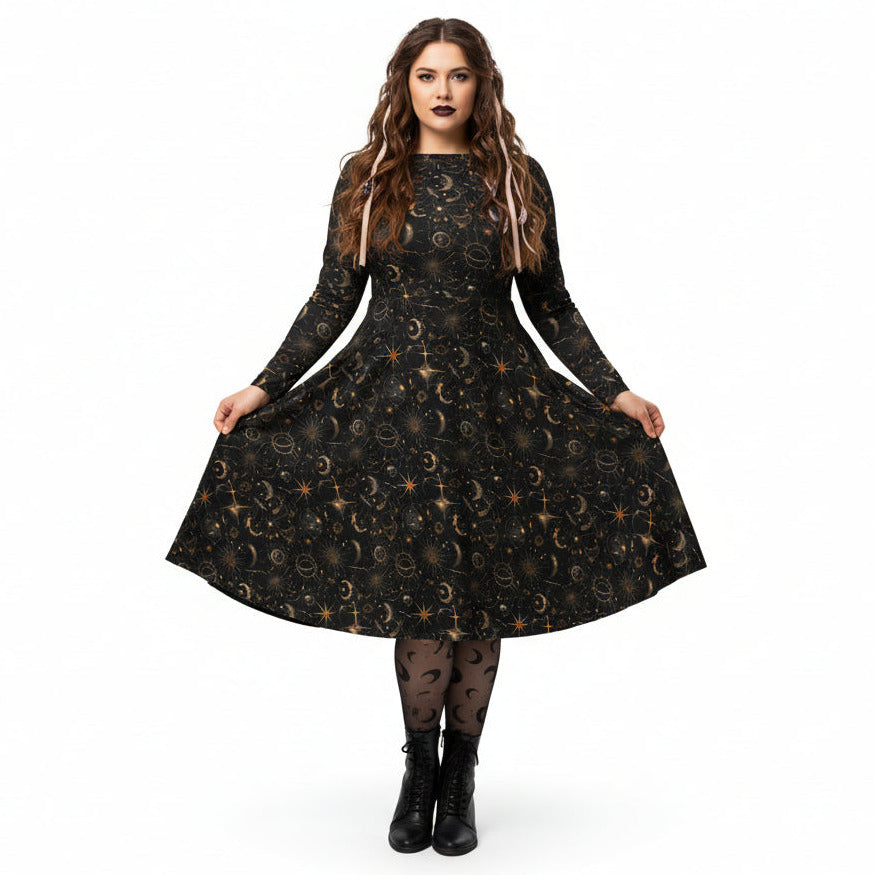 Woman wearing a black dress with celestial sun moon and stars print on a white background