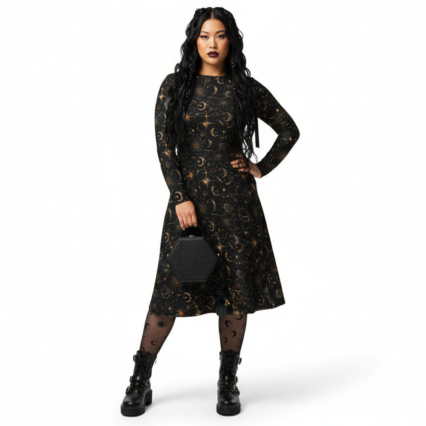Woman wearing a black dress with celestial sun moon and stars print on a white background