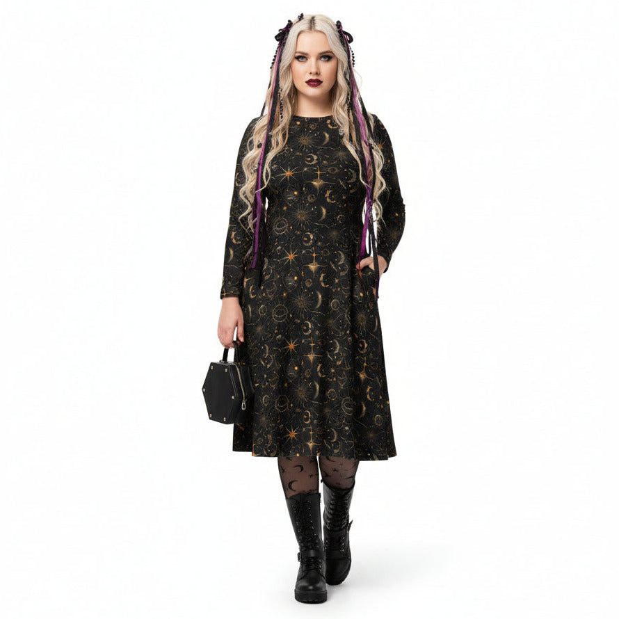 Woman wearing a black dress with celestial sun moon and stars print on a white background