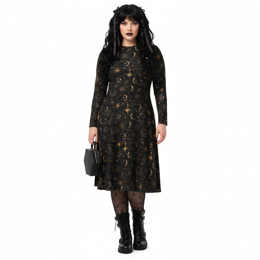 Woman wearing a black dress with celestial sun moon and stars print on a white background
