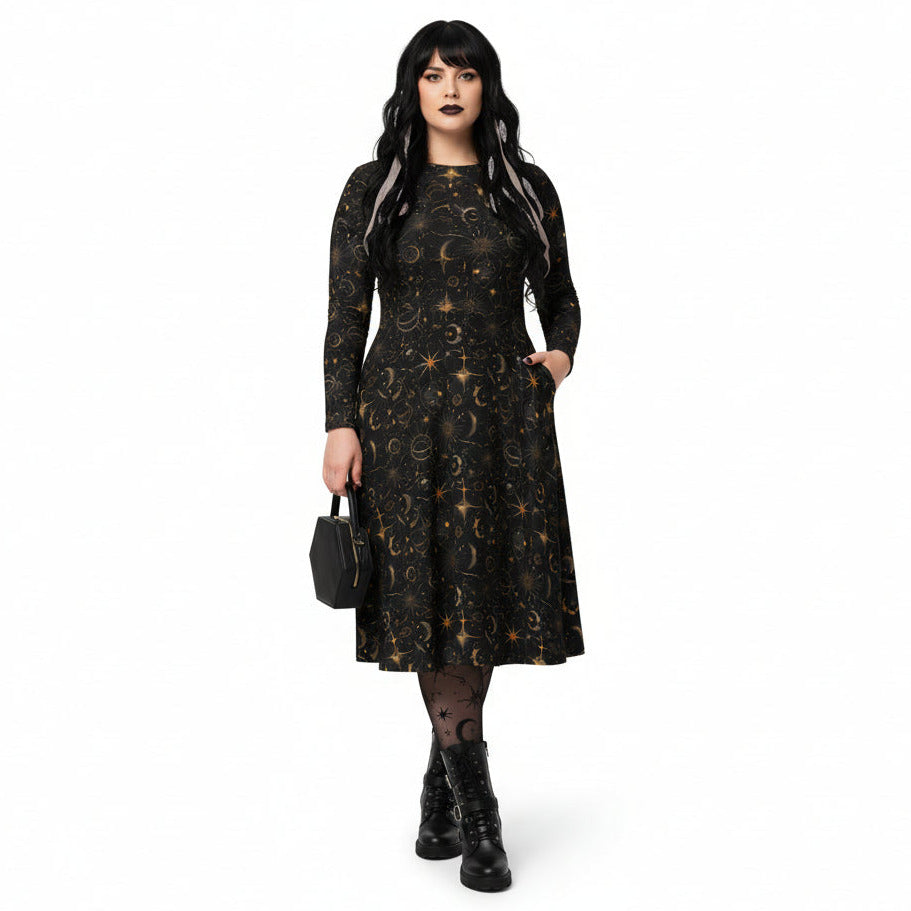 Woman wearing a black dress with celestial sun moon and stars print on a white background