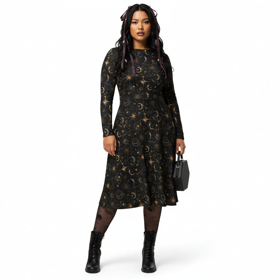 Woman wearing a black dress with star and moon print on a white background