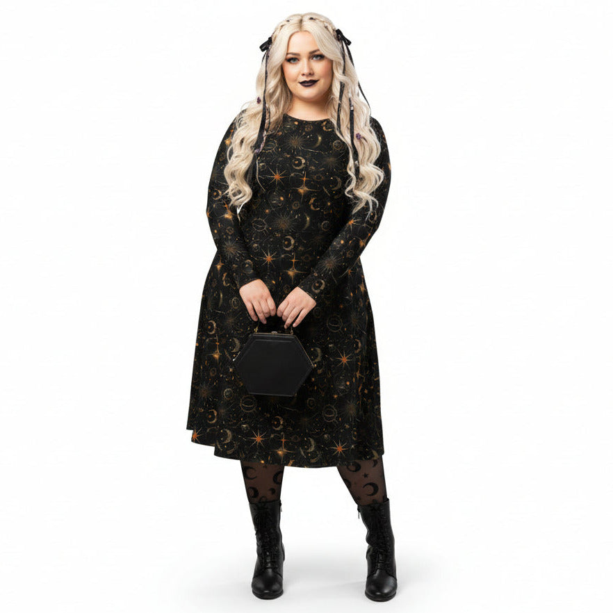 Woman wearing a black dress with celestial sun moon and stars print on a white background