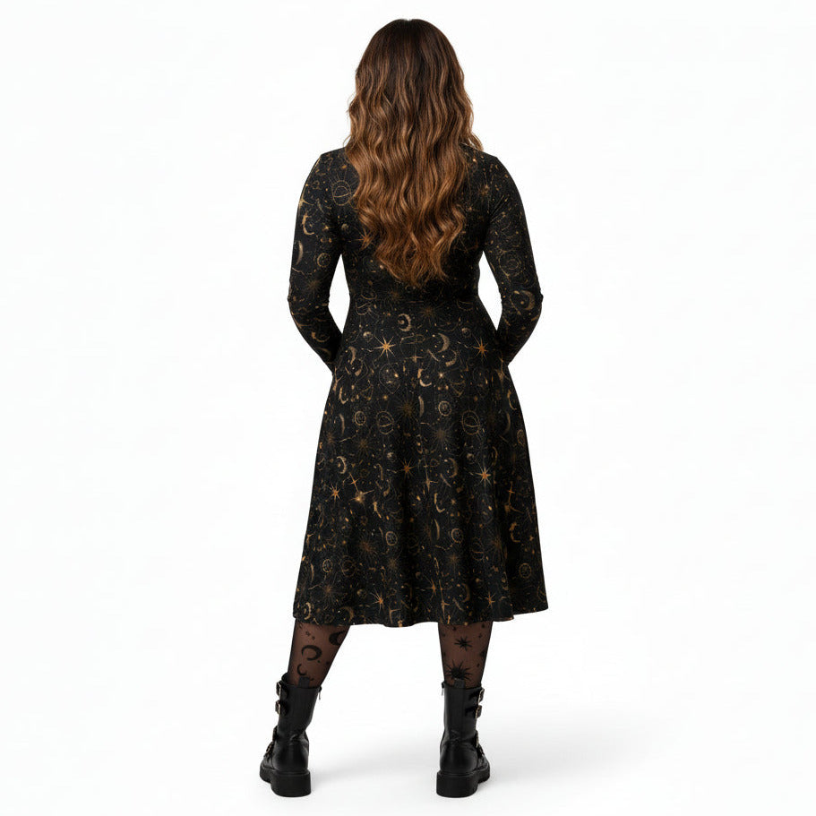 Woman wearing a black dress with celestial sun moon and stars print on a white background