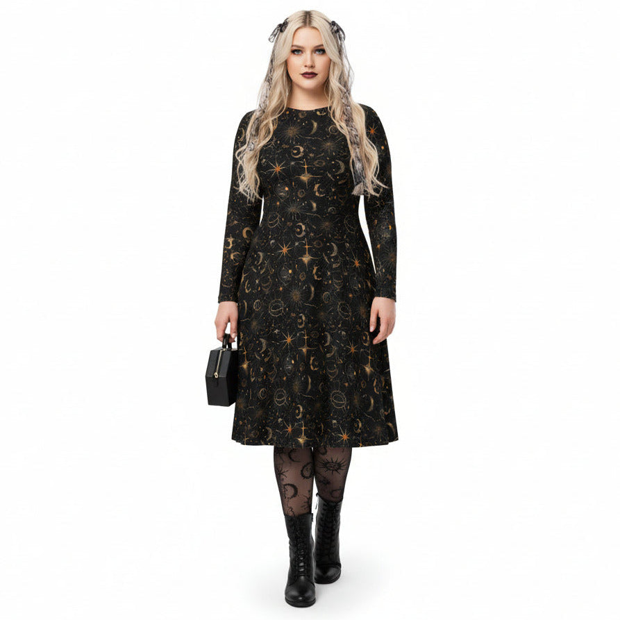 Woman wearing a black dress with celestial sun moon and stars print on a white background