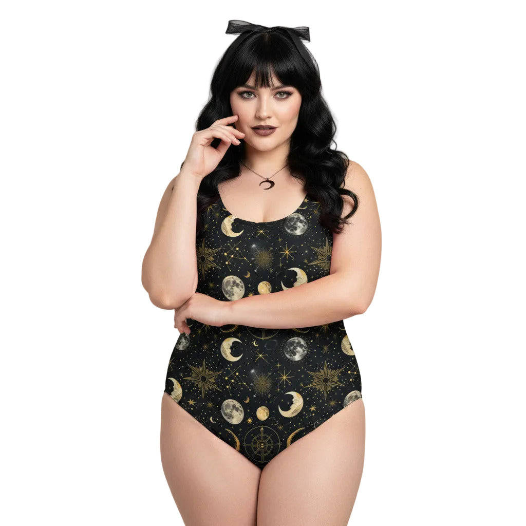 Plus size woman wearing a black celestial one piece swimsuit with gold sun, moon, and star patterns in a gothic style.