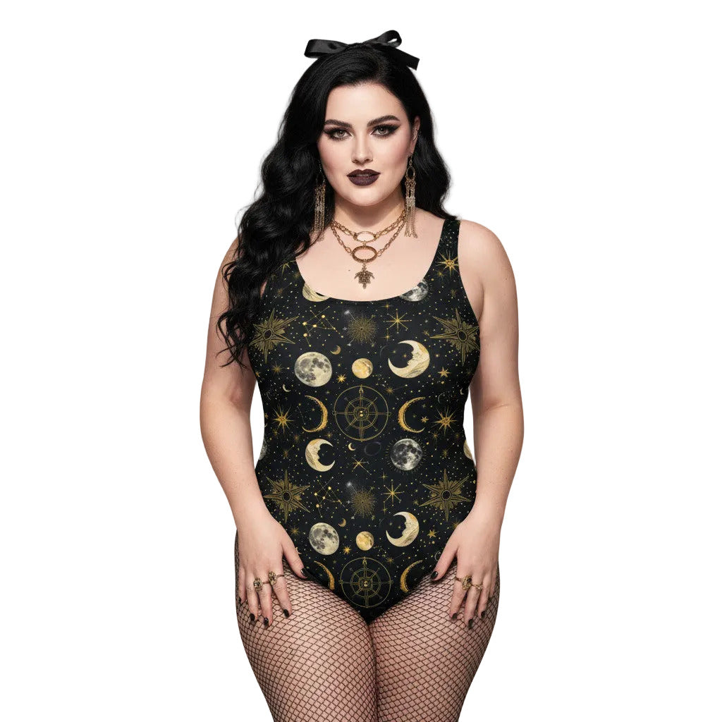 Woman wearing a black celestial one piece swimsuit with gold sun, moon, and star patterns in a gothic style.