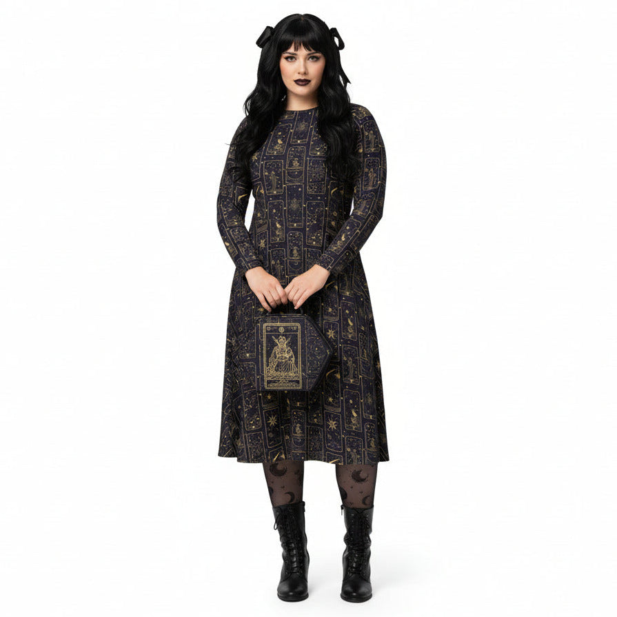 Woman wearing a celestial tarot card print dress holding a matching bag on a white background
