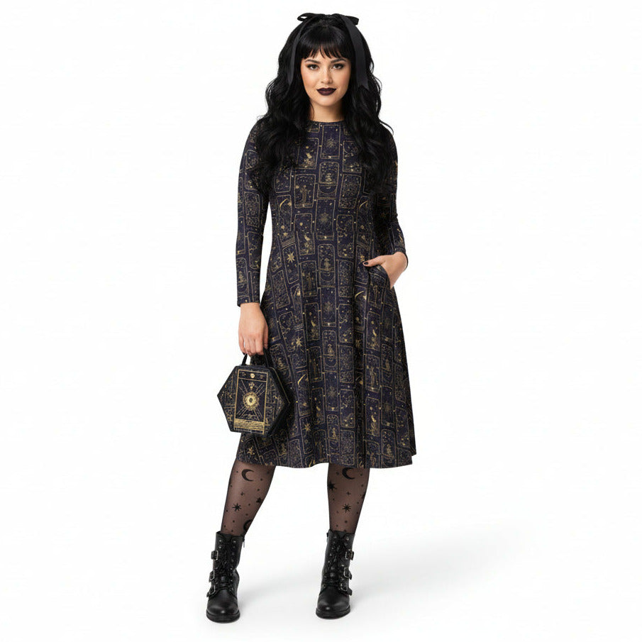 Woman wearing a black celestial tarot card print dress with long sleeves on a white background