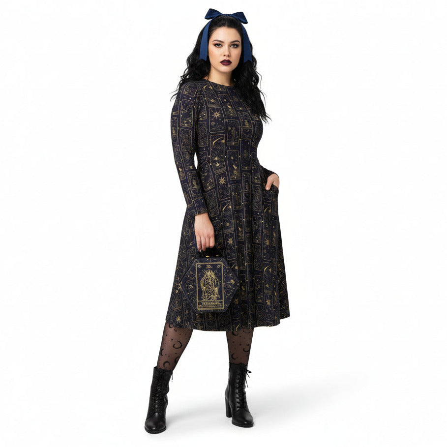 Woman wearing a black celestial tarot card print dress with a brooch on a white background