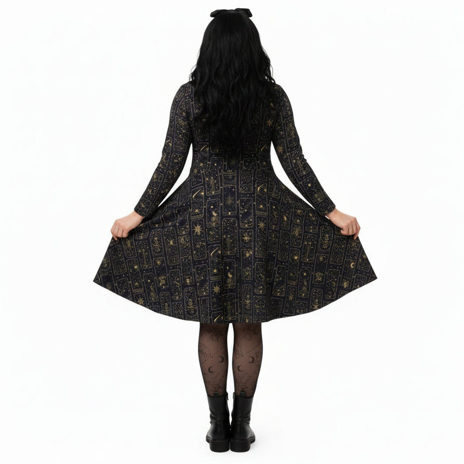 Person wearing a celestial tarot card print dress on a white background