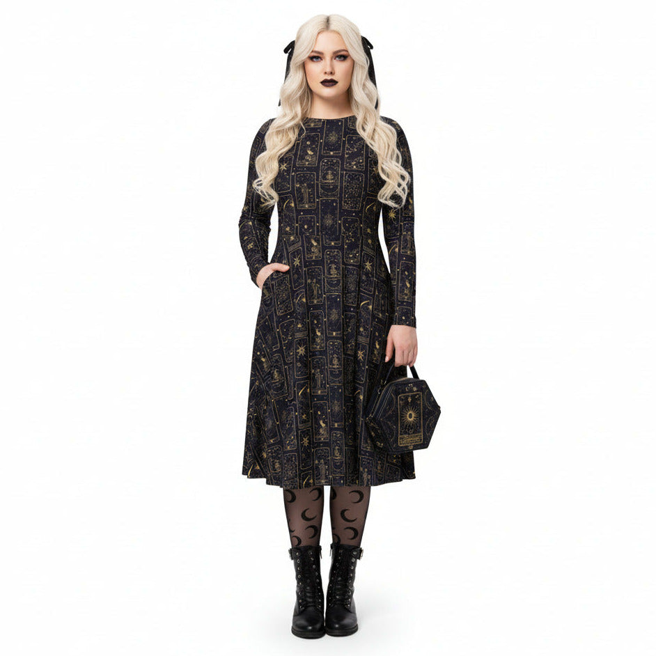 Woman wearing a black celestial tarot card print dress with a matching bag on a white background