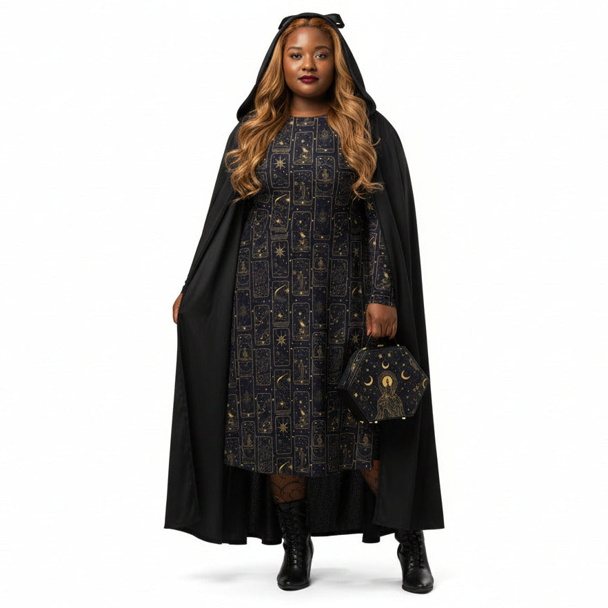 Woman wearing a celestial tarot card print dress with a cape and holding a matching handbag on a white background