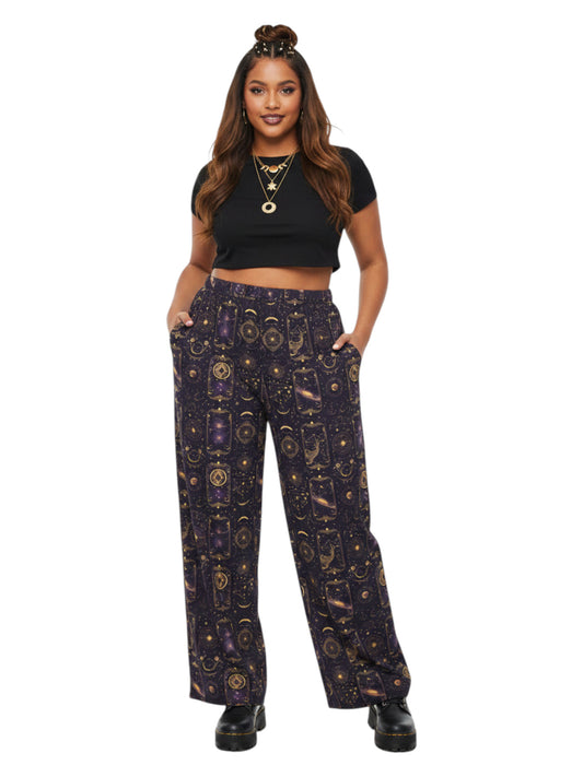 Plus-size model wearing Whimsigoth Tarot Card Celestial wide leg lounge pants with sun moon stars pattern and side pockets.