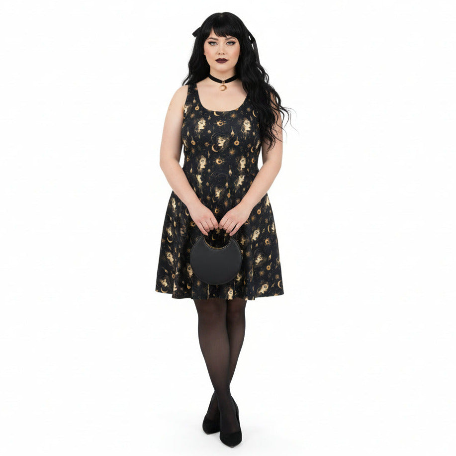 Woman wearing a black dress with gold patterns on a white background