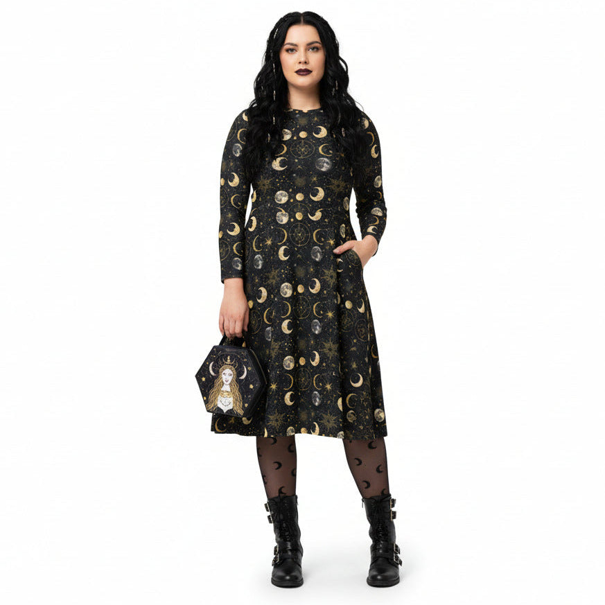 Woman wearing a black dress with moon phase pattern holding a matching bag on a white background