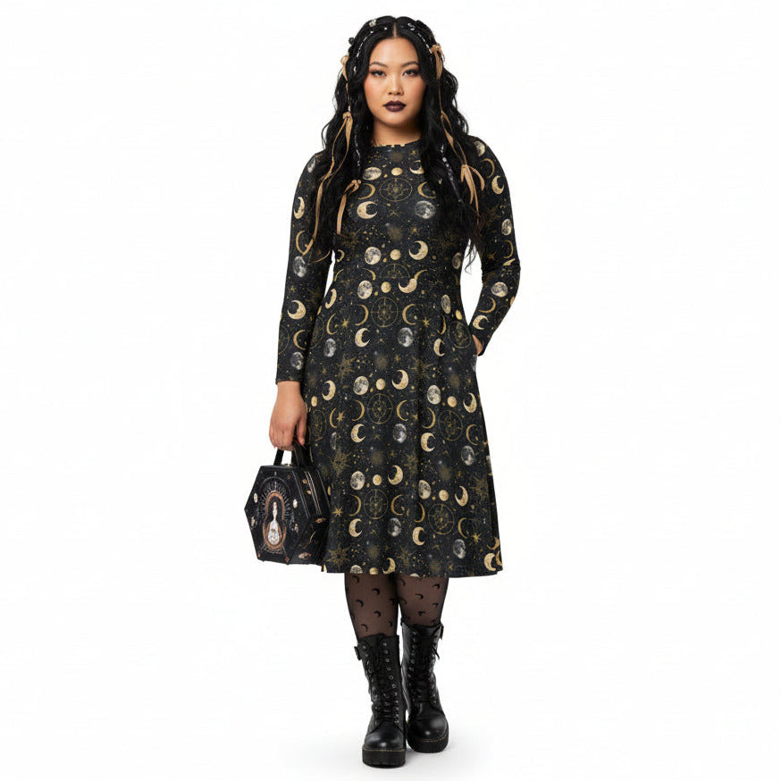 Woman wearing a black dress with celestial moon phase print on a white background