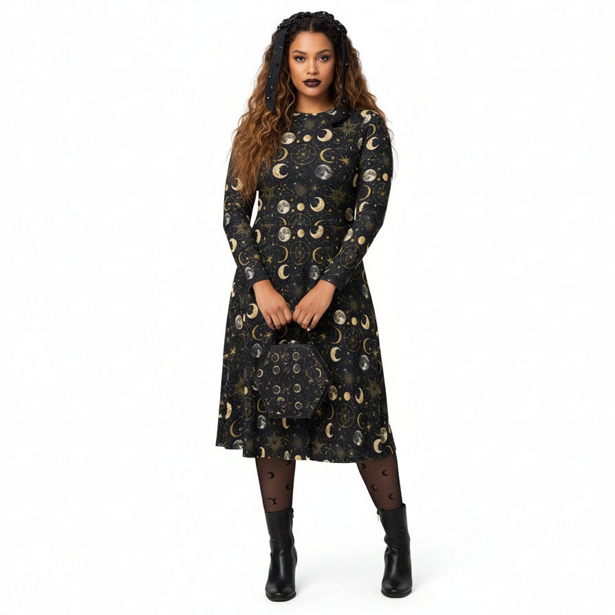 Woman wearing a black dress with celestial moon phase print on a white background
