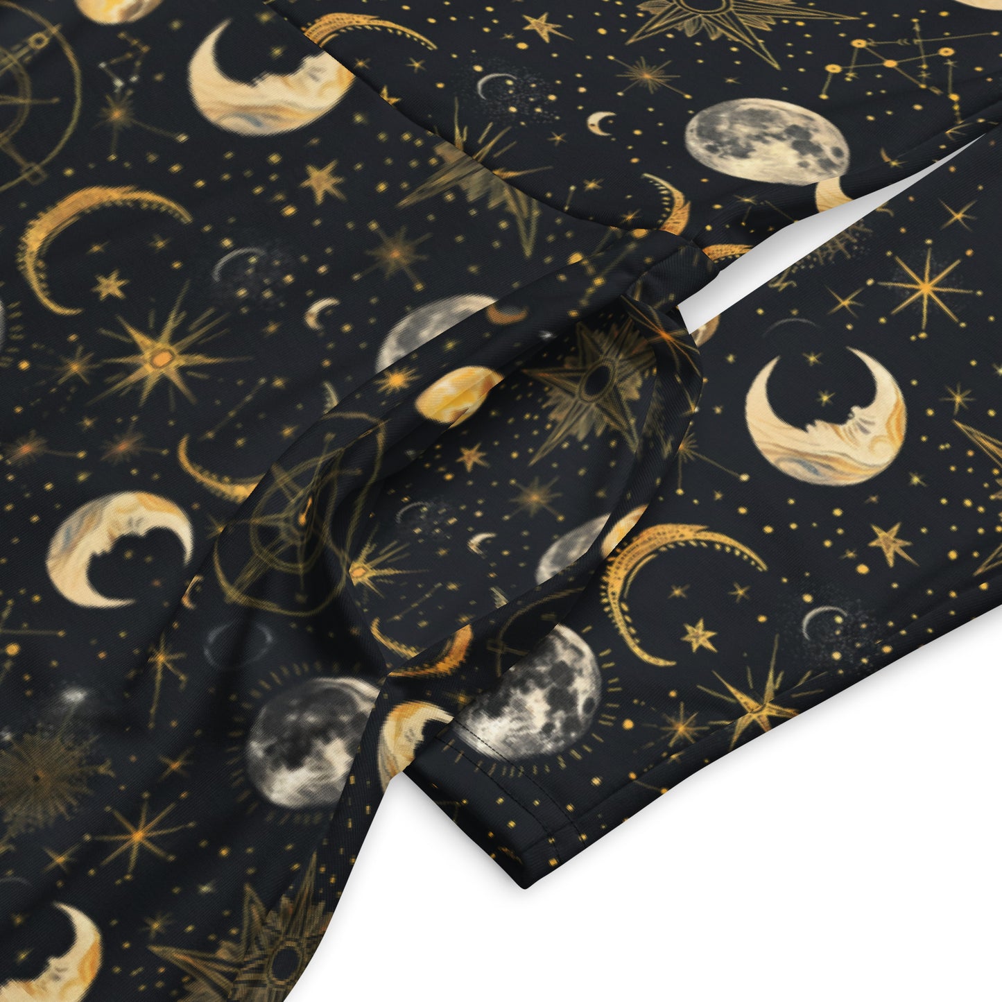 dress with celestial pattern featuring moons, stars, and constellations on a dark background.