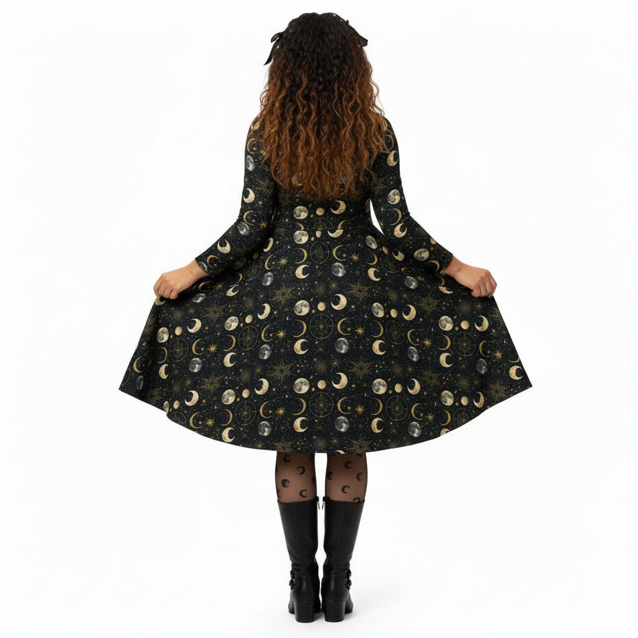 Person wearing a black dress with moon phase pattern on a white background