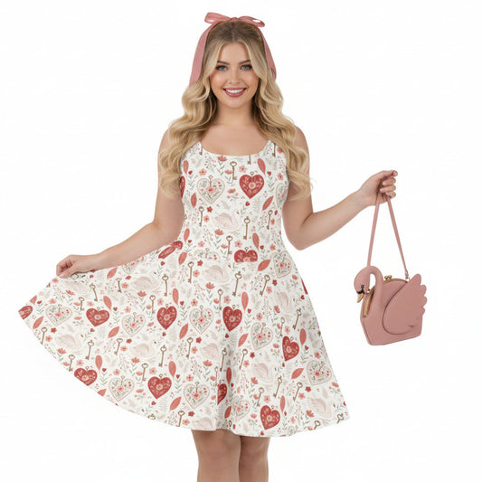 Woman wearing a floral dress with heart patterns and holding a matching pink handbag on a white background