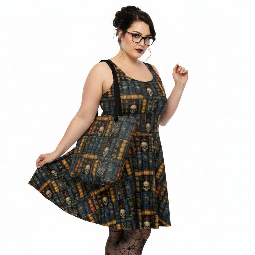 Woman holding a Dark Academia tote bag with gothic bookshelf print, skulls, and spiderwebs on vintage book spines. She is also wearing the matching dress.