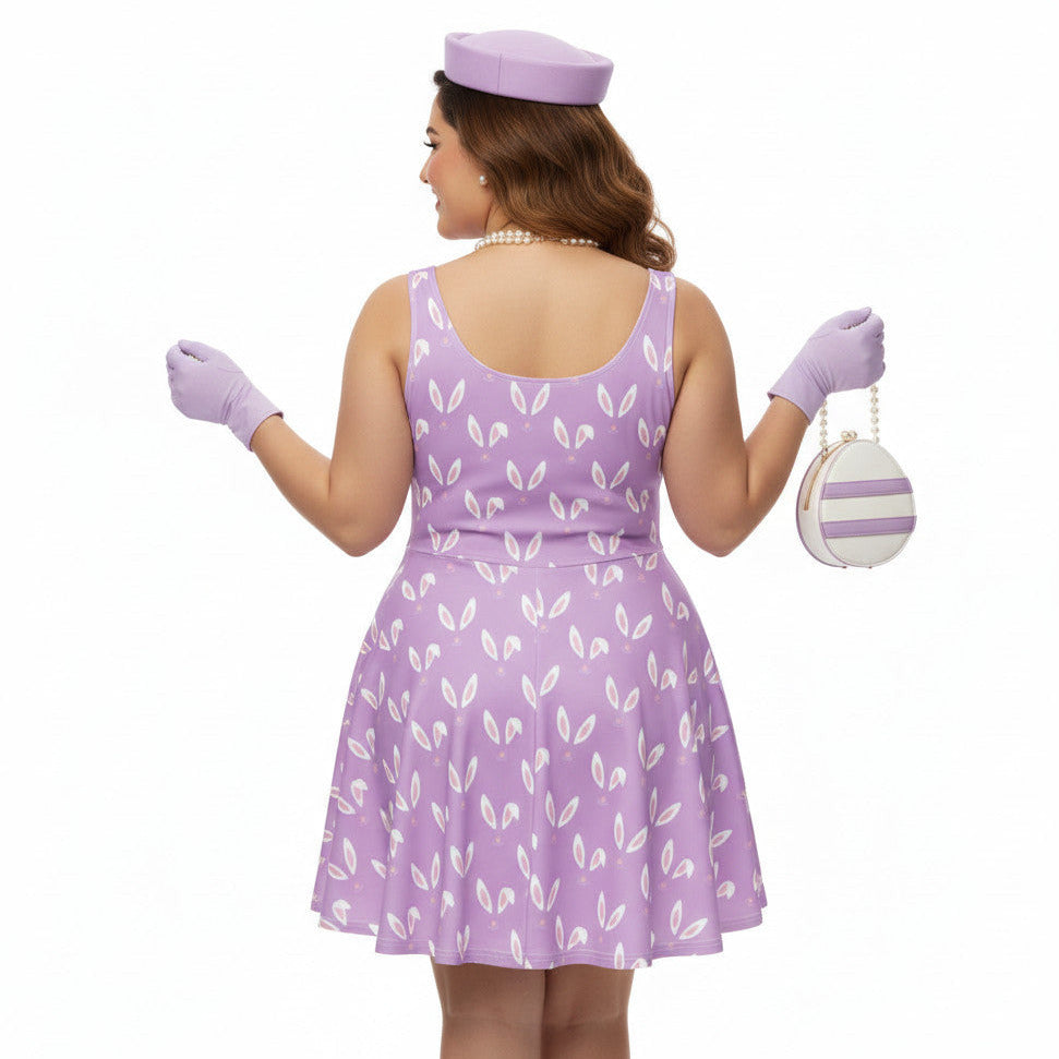Woman wearing a lavender purple plus size 1950s vintage style swing dress with white Easter bunny print, matching pillbox hat, and pearl necklace.