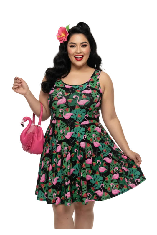 Plus size woman wearing a 1950s vintage-inspired fit and flare swing dress with a tropical flamingo and watermelon print.