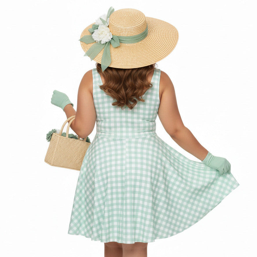 Plus size woman wearing a pastel green and white gingham 1950s vintage-style swing dress with a straw hat and gloves.