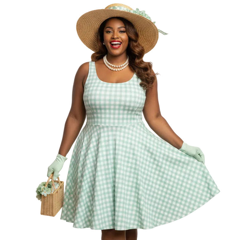 Plus size woman wearing a pastel green and white gingham 1950s vintage-style swing dress with a straw hat and gloves.