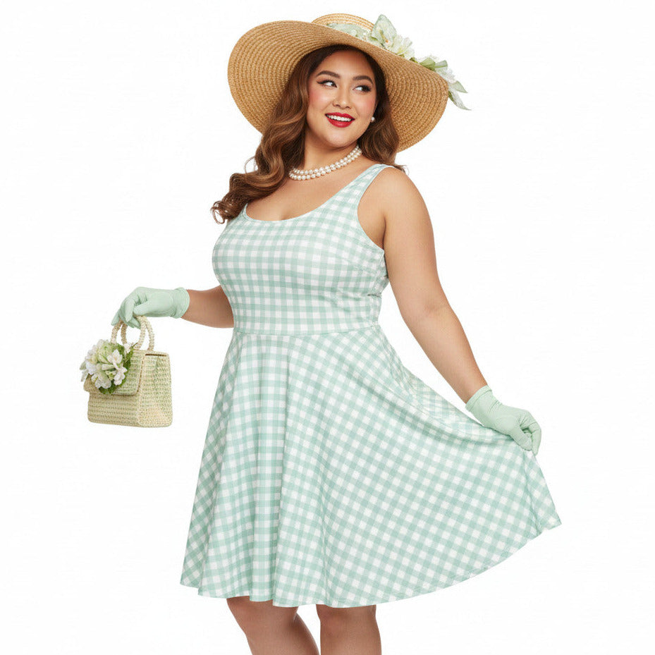 Plus size woman wearing a pastel green and white gingham 1950s vintage-style swing dress with a straw hat and gloves.