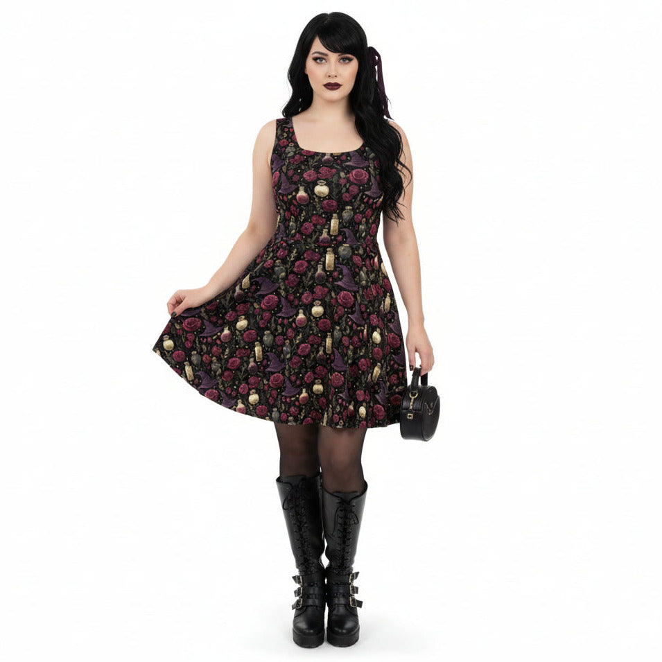 Woman wearing a black floral dress with gold accents on a white background