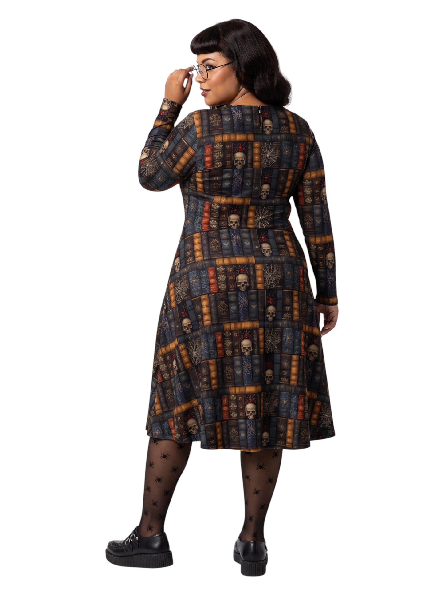 Plus-size model smiling in a Dark Academia midi dress featuring a bookshelf print with vintage books, skulls, and spiderwebs, designed with long sleeves and a fit-and-flare silhouette.