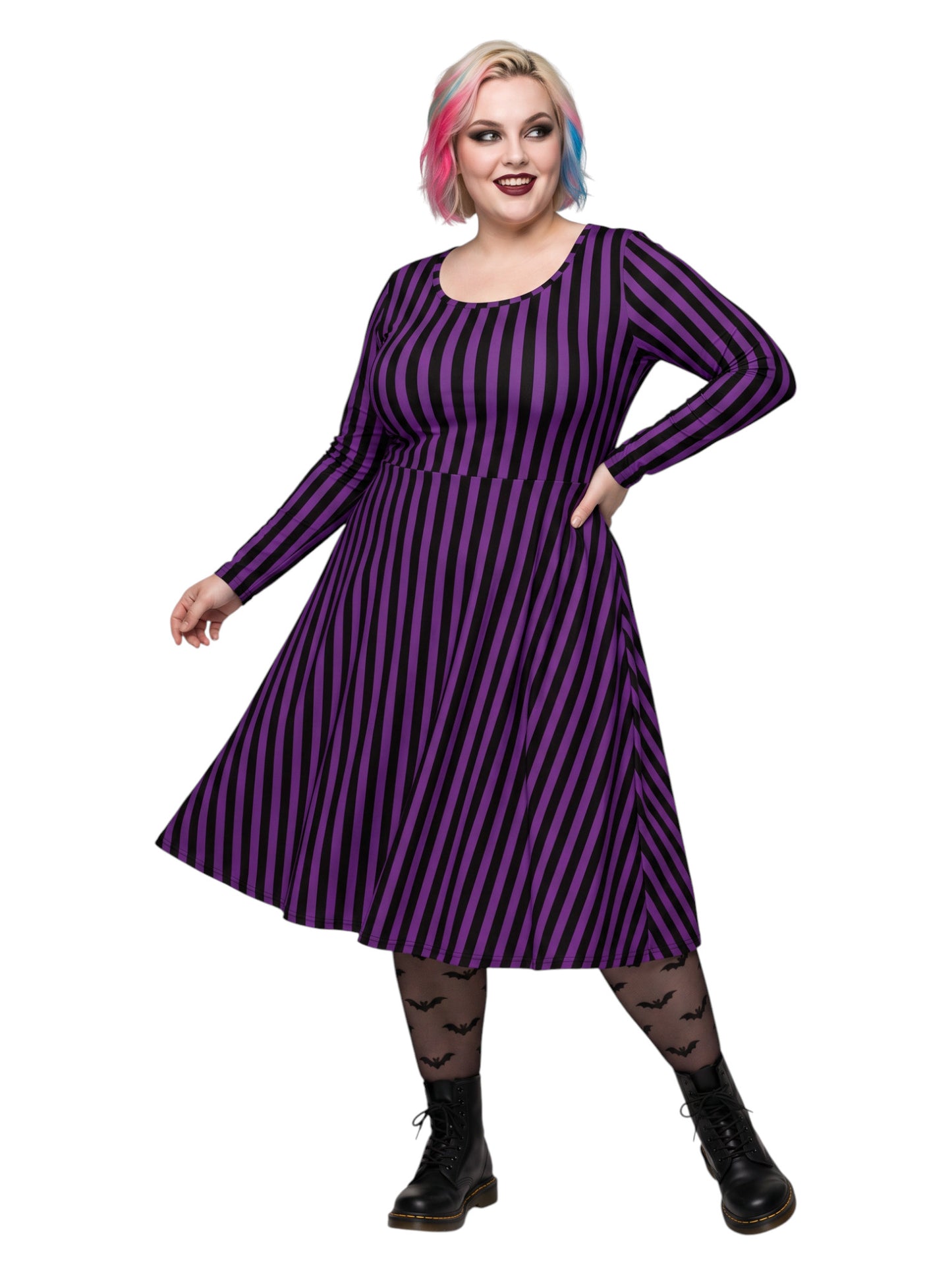 Plus size woman modeling gothic purple and black vertically striped long sleeve fit and flare midi dress with side pockets