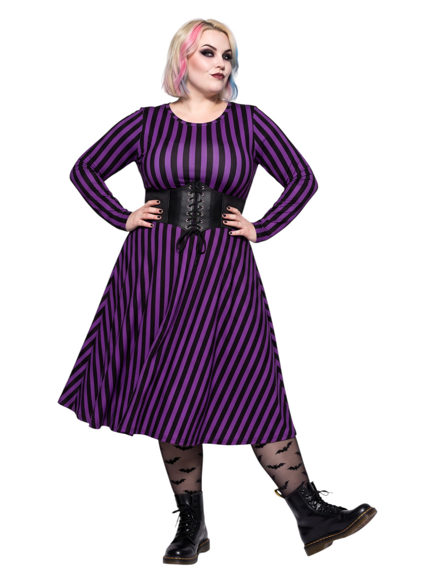Plus size woman modeling gothic purple and black vertically striped long sleeve fit and flare midi dress with side pockets