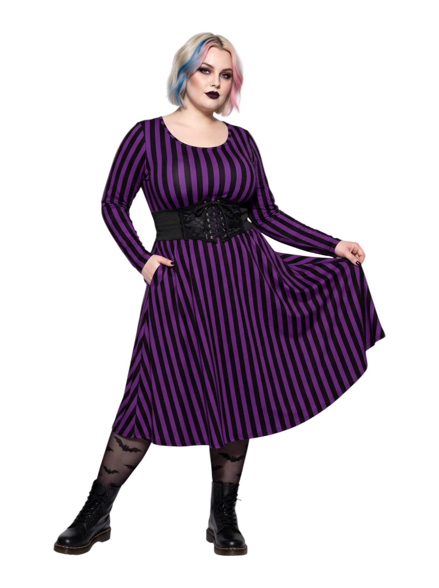Plus size woman modeling gothic purple and black vertically striped long sleeve fit and flare midi dress with side pockets