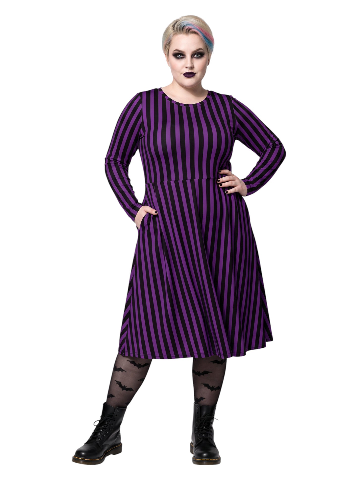 Plus size woman modeling gothic purple and black vertically striped long sleeve fit and flare midi dress with side pockets
