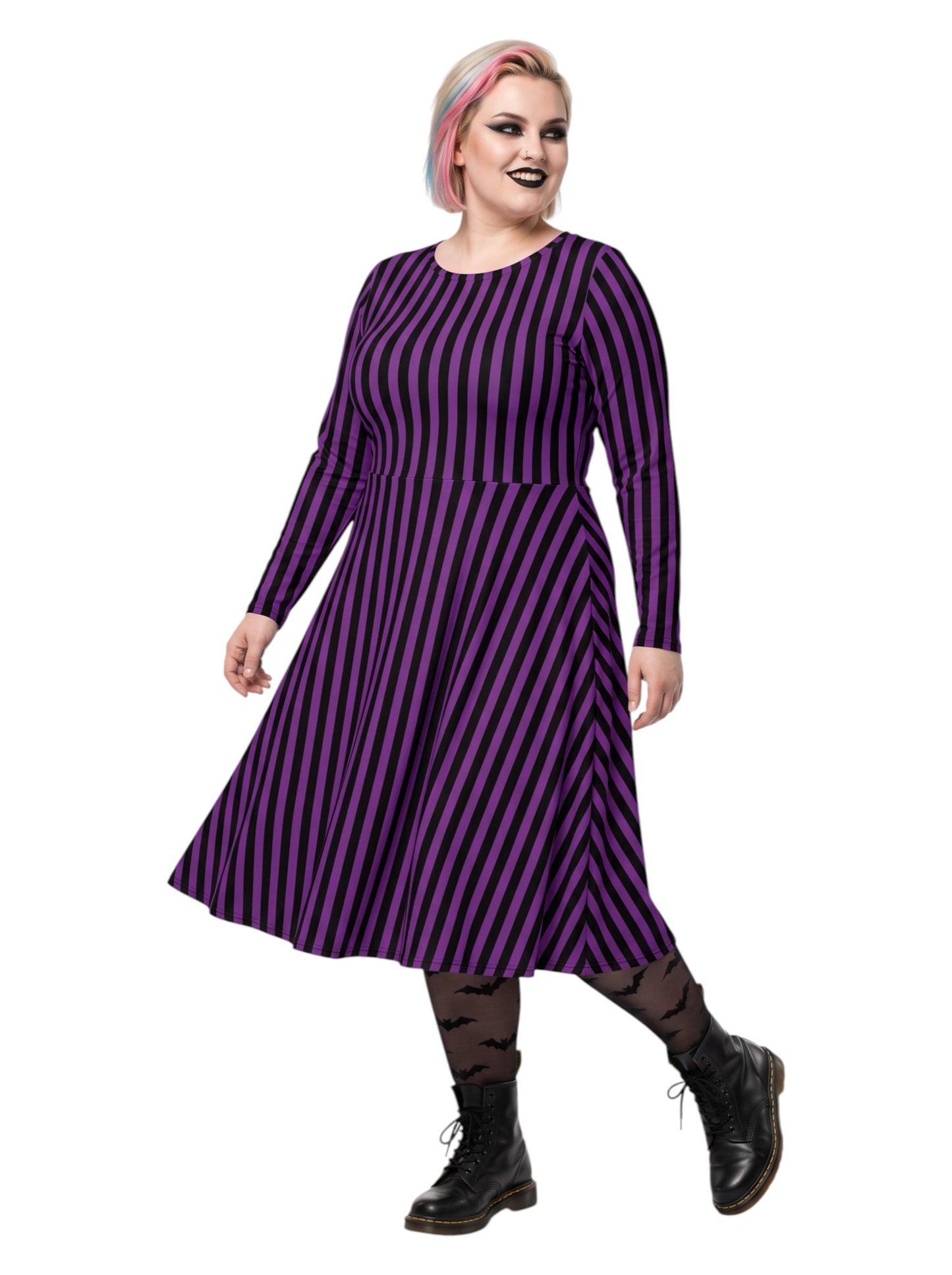 Plus size woman modeling gothic purple and black vertically striped long sleeve fit and flare midi dress with side pockets
