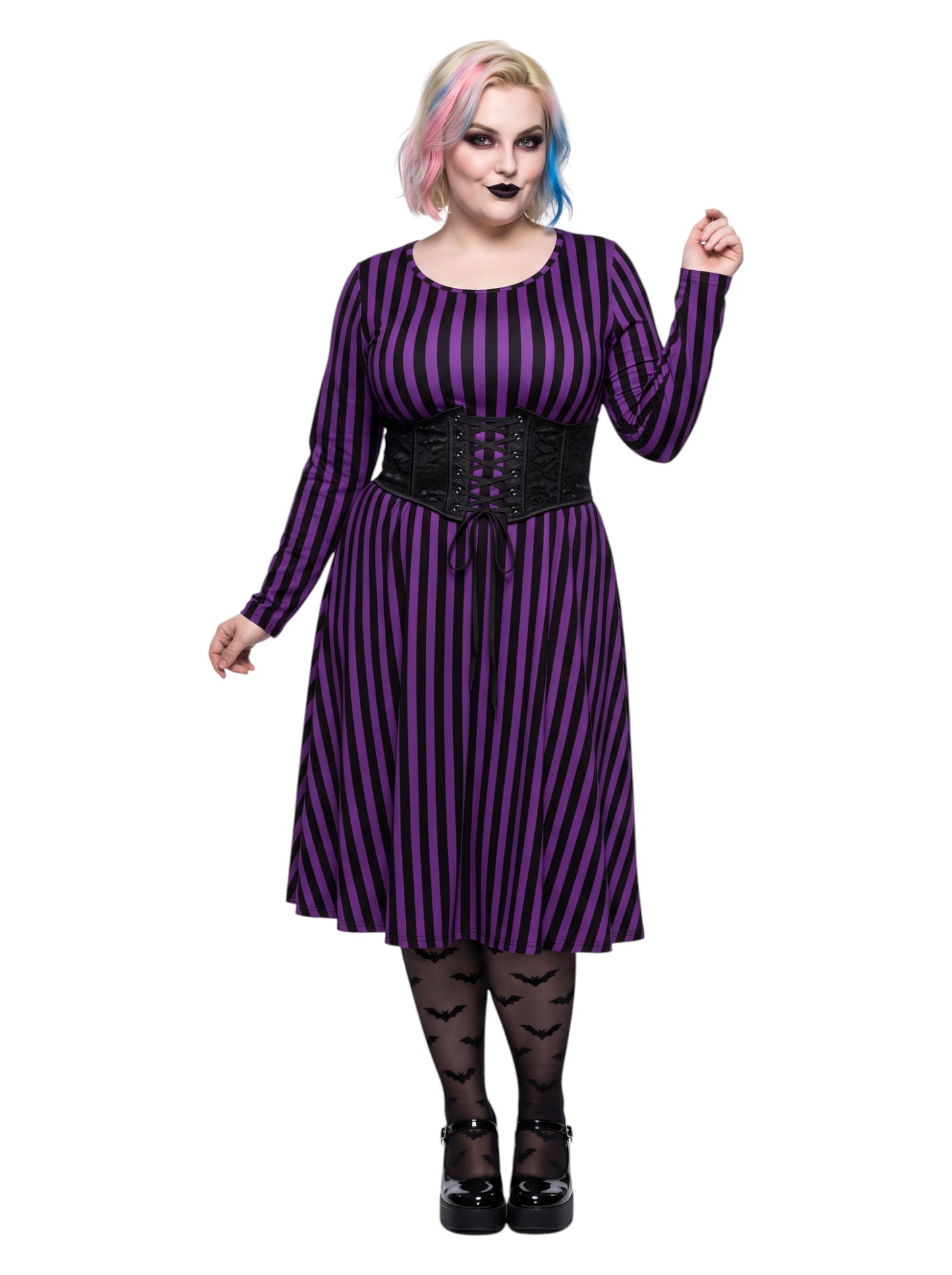 Plus size woman modeling gothic purple and black vertically striped long sleeve fit and flare midi dress with side pockets
