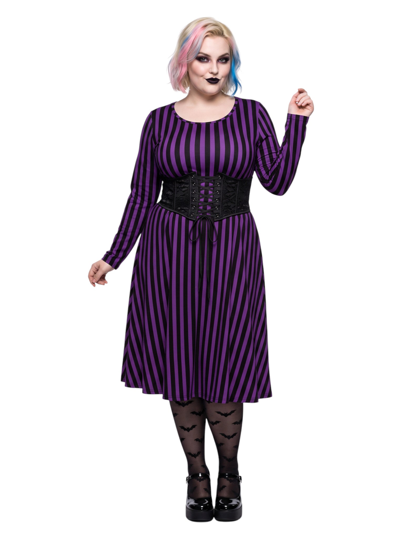 Plus size woman modeling gothic purple and black vertically striped long sleeve fit and flare midi dress with side pockets